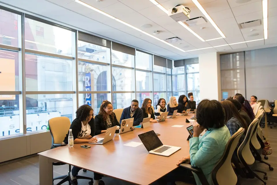 Group of women talking around a wooden table