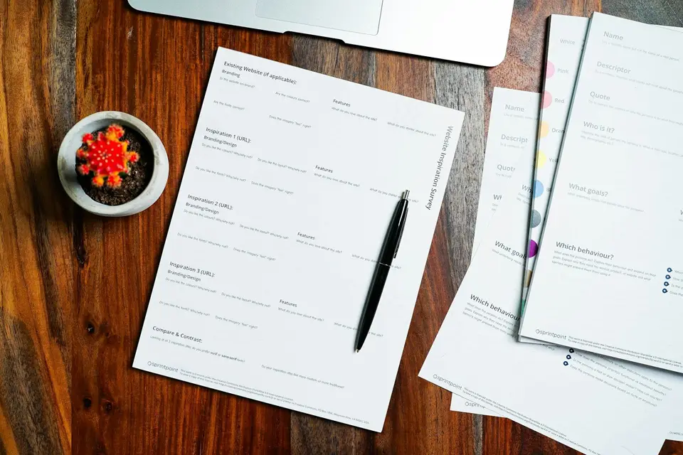 Paper and a pen on a wooden table