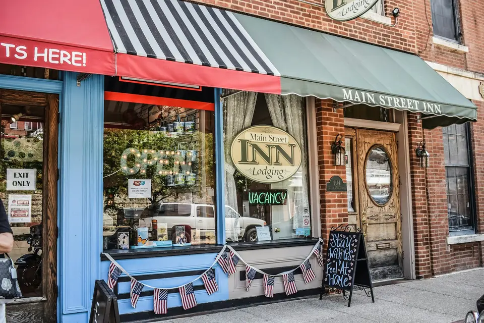 Man walking past a storefront on a city street