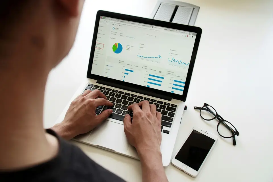 Person reviewing charts on a laptop