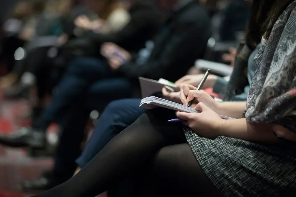 People seated on chairs at an event
