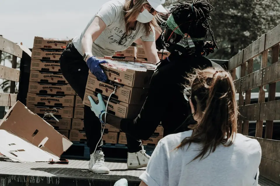 Volunteers loading boxes of donated produce