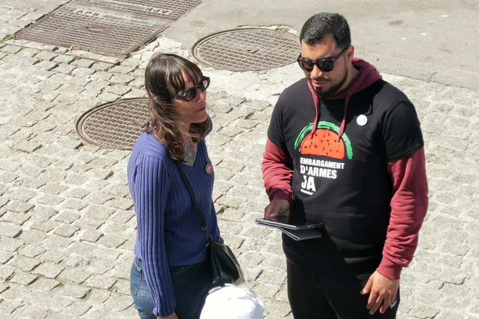 Two people talking at an outdoor table