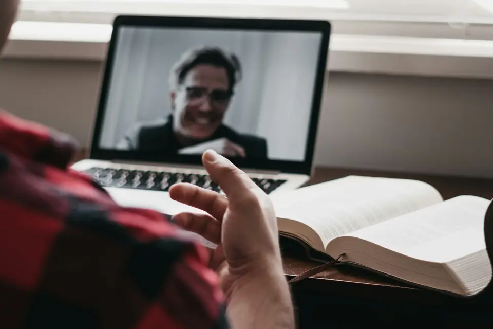 Person in a plaid shirt on a video call