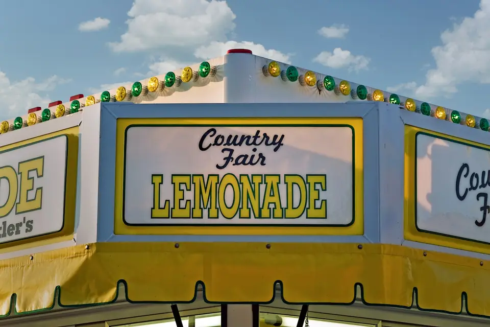 Lemonade stand with string lights at a country fair