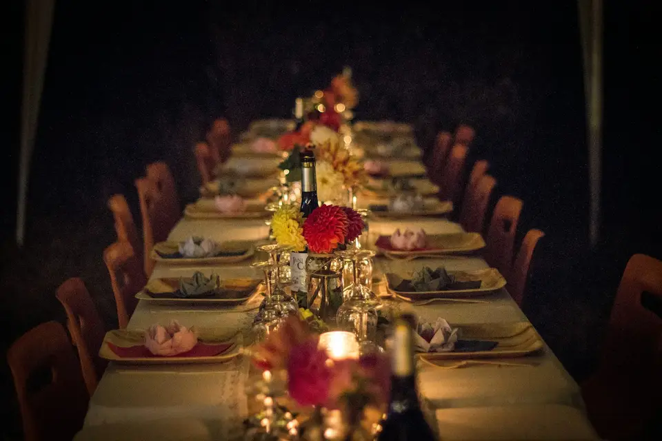Long dinner table set with flowers for an evening event