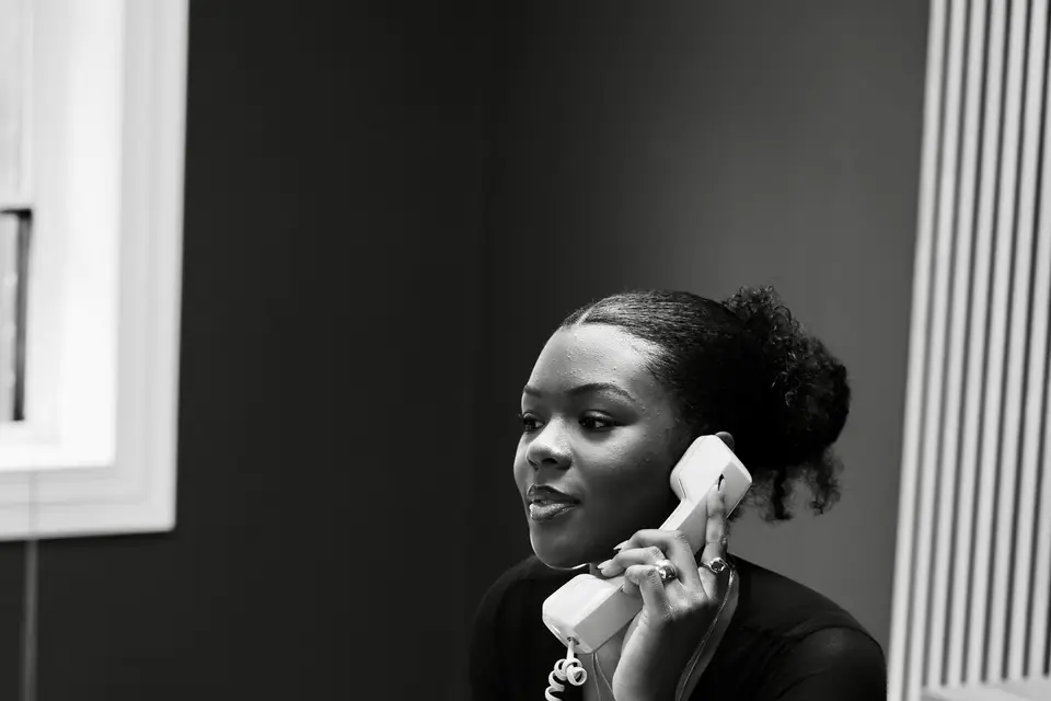 Woman talking on a desk phone
