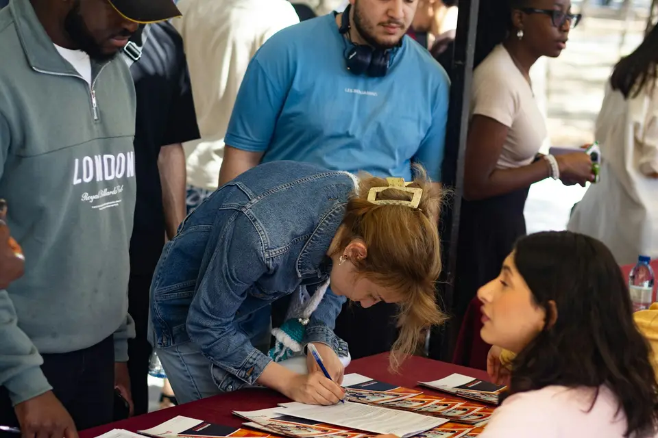 Woman signing forms at a table