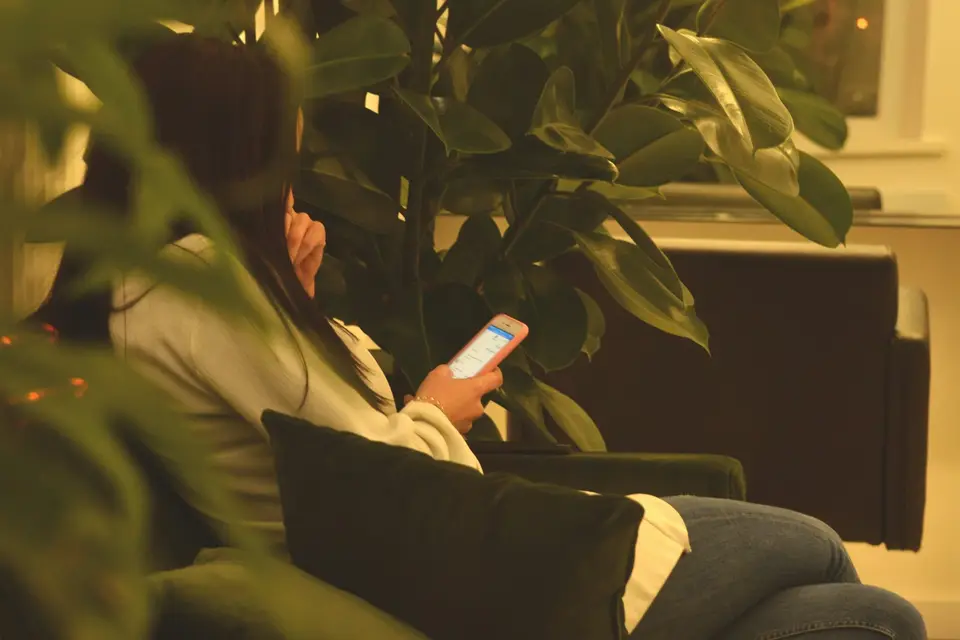 Person using a smartphone on a sofa