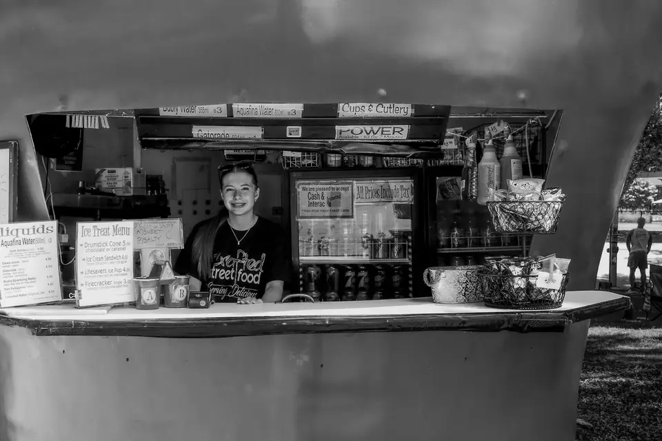 Smiling volunteer working at an outdoor food stand