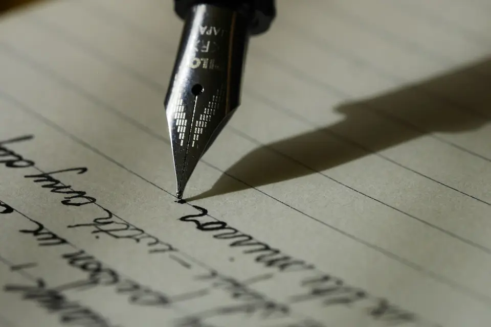 Fountain pen resting on lined paper
