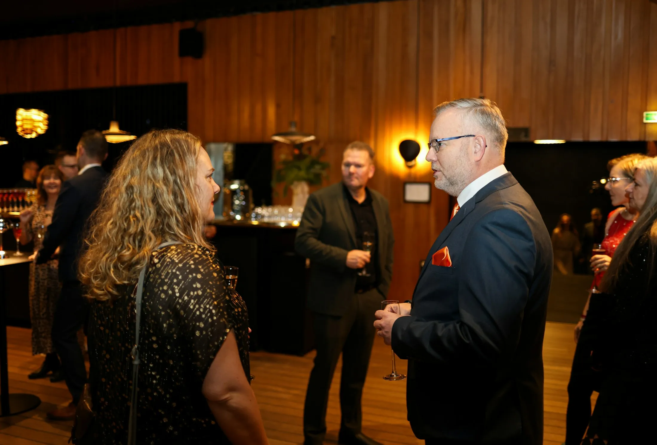 Business professionals talking at a networking reception.