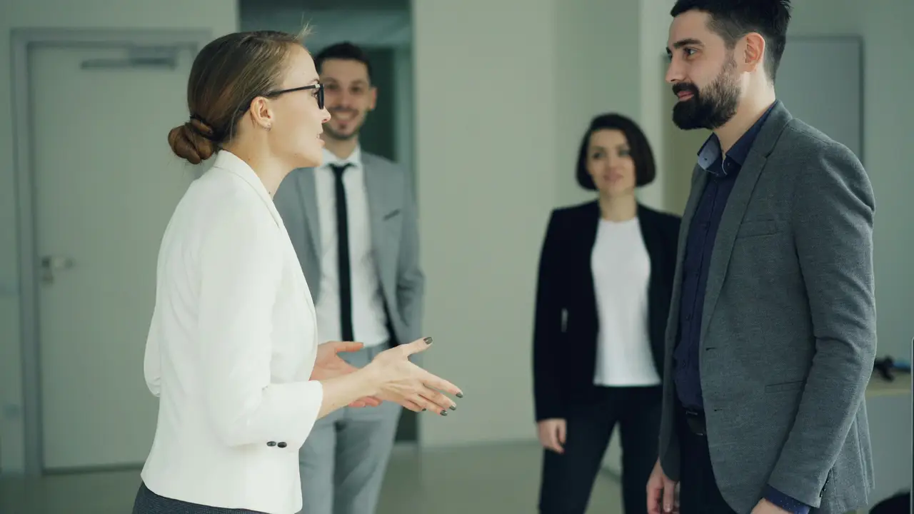 A local team welcoming a colleague at a meeting.