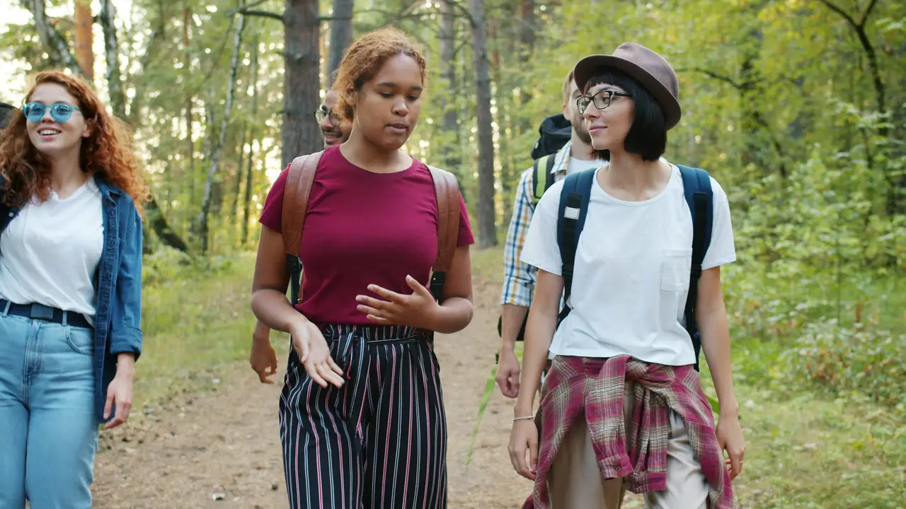 Club members hiking together on a forest trail.