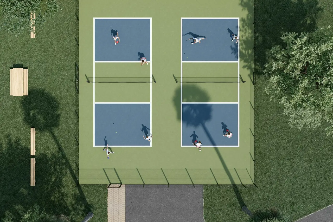 An aerial view of players on side-by-side outdoor courts.