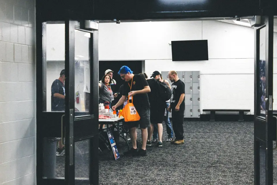 People gathered around a table at an indoor event