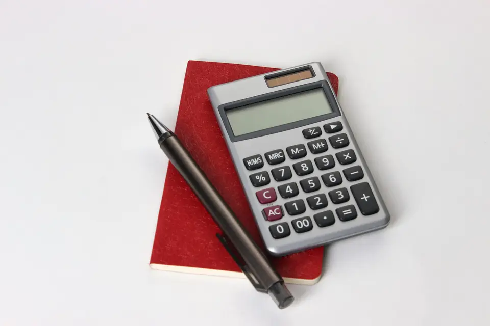 Calculator next to a pen