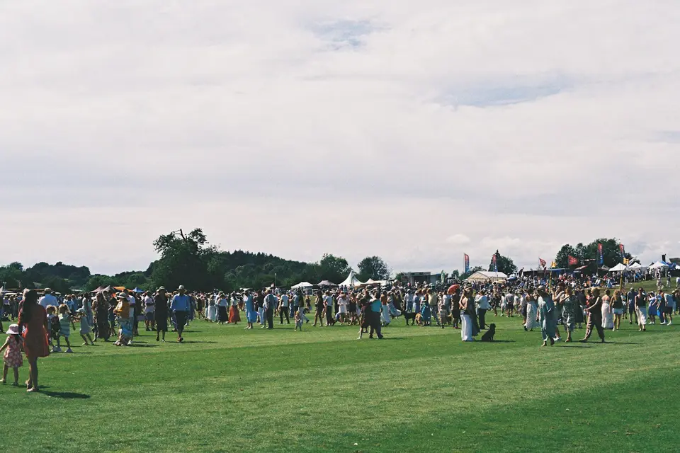 Large crowd gathered on a green field