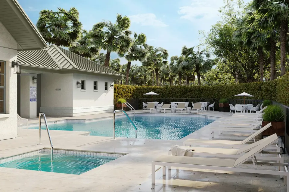 Community pool area with lounge chairs and palm trees