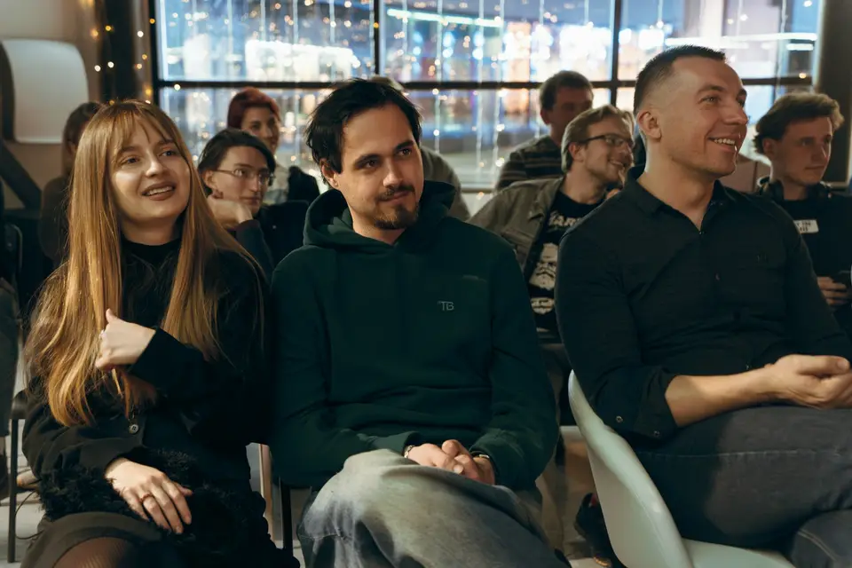 Professionals sitting in a room listening to a session