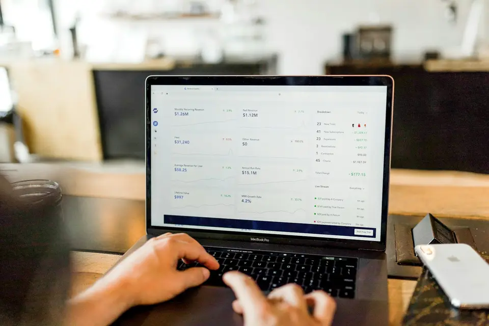 A person working with a financial overview on a laptop.