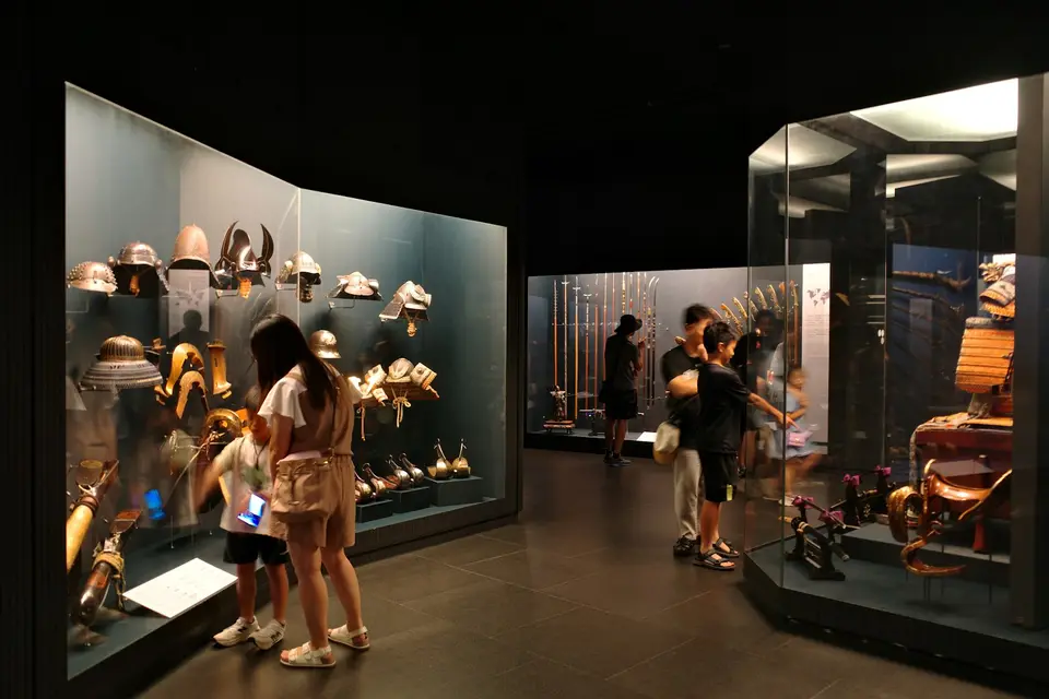 A family exploring an exhibit together in a museum.