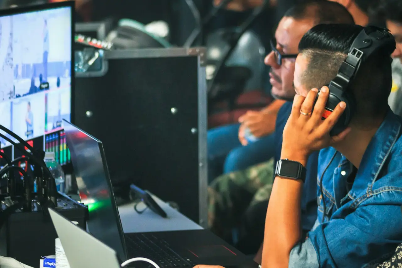 A volunteer running audio and video equipment during a service.