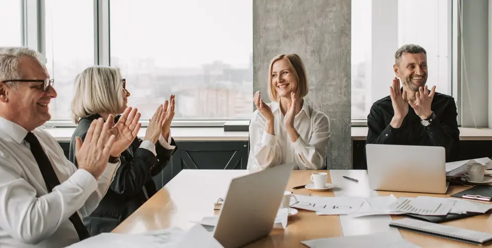 A group applauding during a meeting.