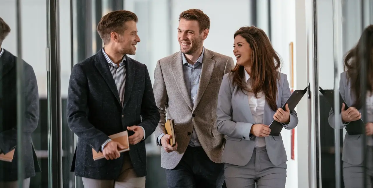 People talking together during a meeting at an office.