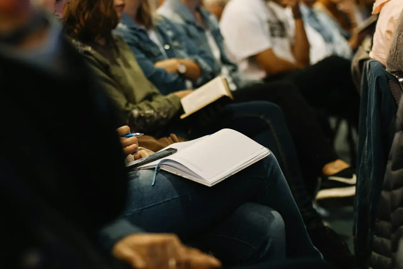 Attendees taking notes during an educational session.