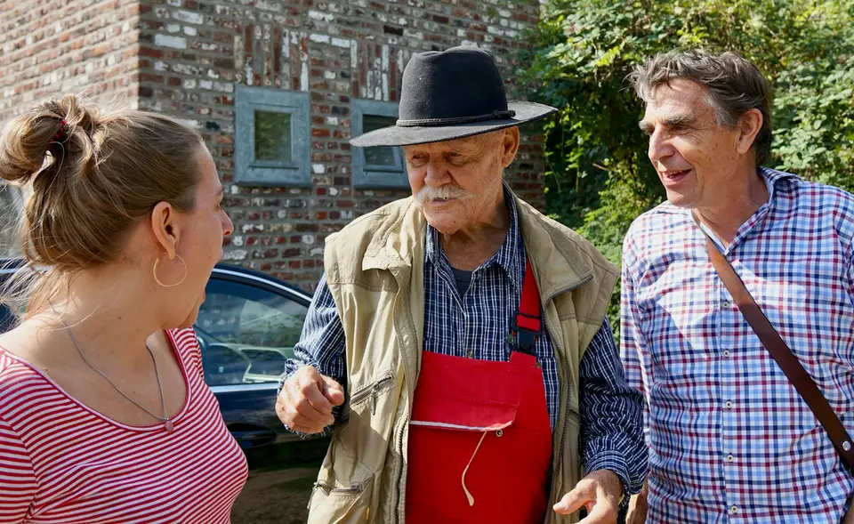 Neighbors chatting together on a residential street.