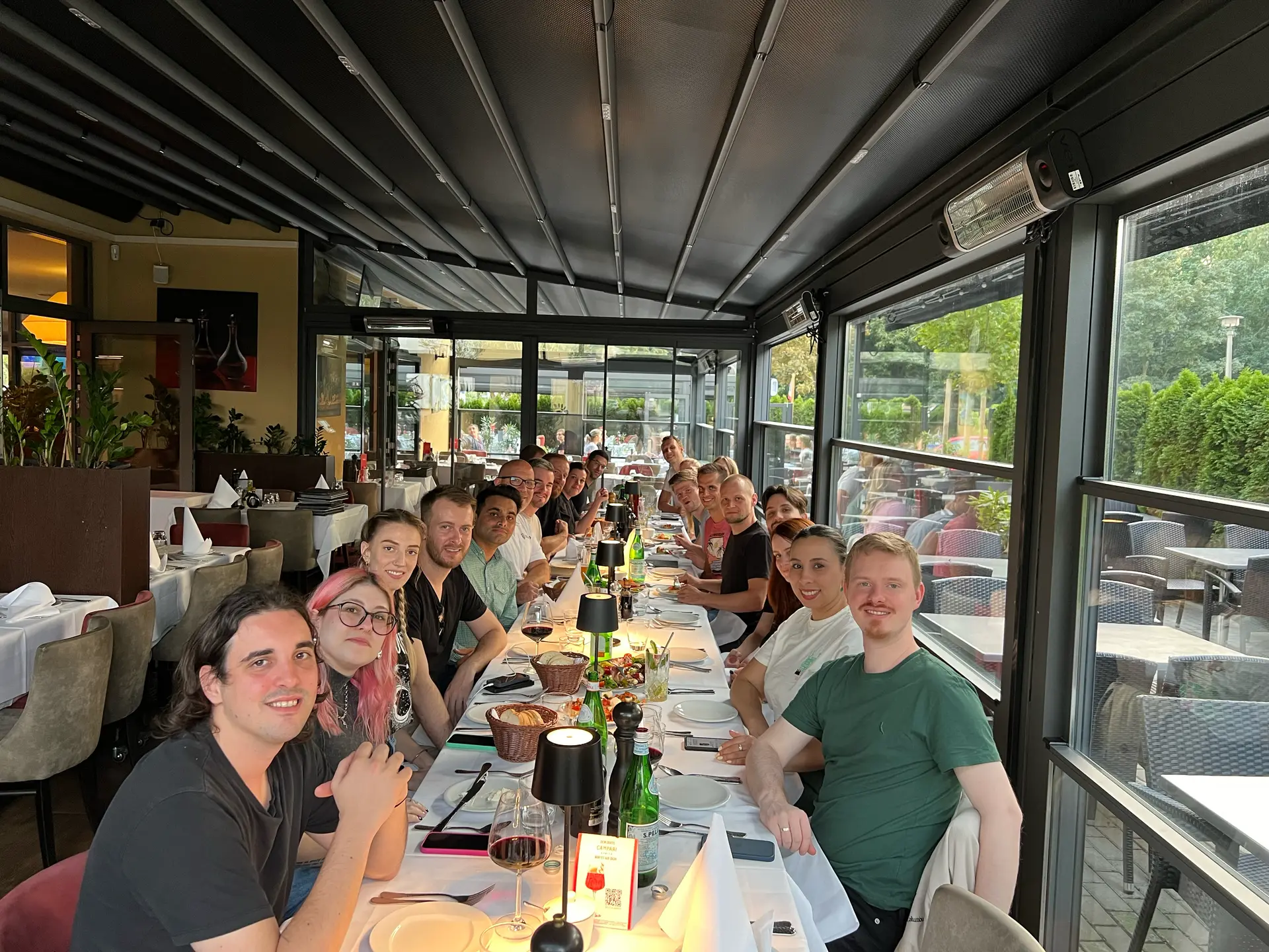 Members of the international campai team together at a long table
