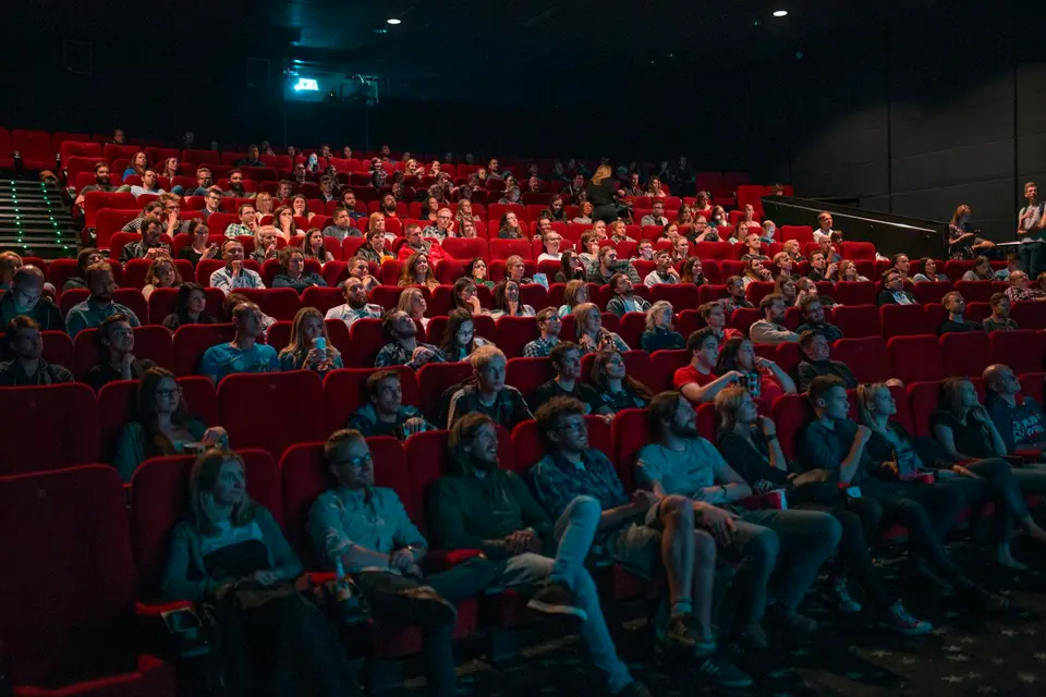 An audience seated in a theater before a performance.