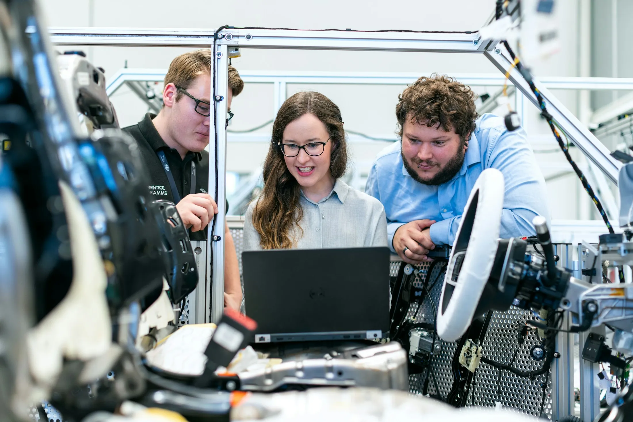 Industry professionals reviewing equipment together in a manufacturing lab.