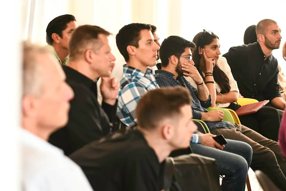 Workshop participants listening attentively to a presenter.